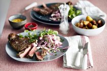 Steak meal for two on table — Stock Photo