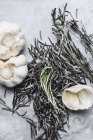 Top view of Rosemary with garlic on marble table — Stock Photo