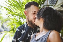 Multi ethnic couple kissing in residential alleyway, Shanghai French Concession, Shanghai, China — Stock Photo