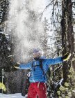 Portrait of male skier throwing snow in air — Stock Photo