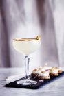 Toffee rum punch with canapes on wooden table — Stock Photo