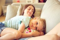 Portrait of girl hugging and resting on pregnant mother's stomach — Stock Photo
