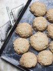 Top view of Freshly baked oatmeal cookies on baking pan — Stock Photo