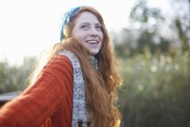 Portrait of red haired woman looking up and smiling — Stock Photo