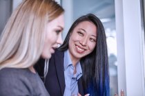 Woman looking at colleague smiling — Stock Photo