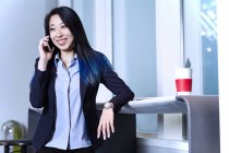 Femme d'affaires passer un appel téléphonique et sourire — Photo de stock
