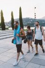 Three young friends strolling on waterfront, Lake Como, Lombardy, Italy — Stock Photo