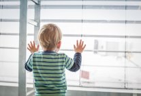 Boy looking out of window — Stock Photo