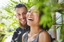 Multi ethnic couple laughing together in residential alleyway, Shanghai French Concession, Shanghai, China — Stock Photo