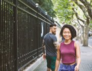 Giovane hipster maschile guardando indietro verso la donna sul marciapiede, Shanghai French Concessione, Shanghai, Cina — Foto stock