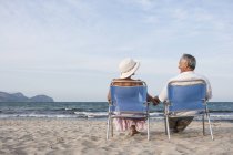 Couple on deckchairs on beach, Palma de Mallorca, Spain — Stock Photo