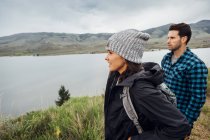Couple hiking, standing beside Dillon Reservoir, looking at view, Silverthorne, Colorado, USA — Stock Photo