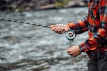 Cropped view of man fishing — Stock Photo