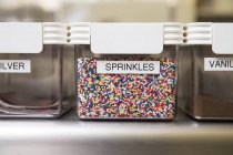 Sprinkles in labelled container, focus on foreground — Stock Photo