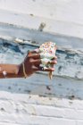 Woman holding melting, dripping ice cream cone, close up of hand — Stock Photo