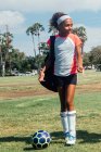 Teenage schoolgirl soccer player on school sports field — Stock Photo