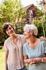 Portrait of senior woman with grown daughter, outdoors, smiling — Stock Photo