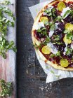 Fresh pizza with salad leaf and beetroot, overhead view — Stock Photo