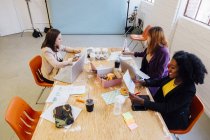 Женщины-коллеги, работающие вместе за столом — стоковое фото