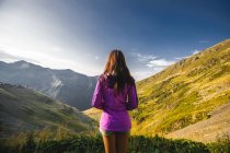 Rear view of young woman looking out over mountain scene, Draja, Vaslui, Romania — Stock Photo