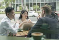 Group of business people meeting at outdoor cafe — Stock Photo