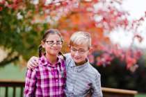 Siblings with arms around each other dressed up as nerds — Stock Photo