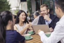 Group of business people having coffee at cafe — Stock Photo