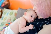 Woman with baby boy on chest — Stock Photo
