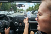 Close up de jovem mulher em viagem de carro segurando fotografia instantânea, Breckenridge, Colorado, EUA — Fotografia de Stock