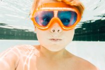 Portrait of young boy in swimming pool, underwater view — Stock Photo