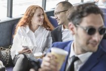 Businessman and woman chatting on passenger ferry — Stock Photo
