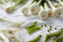 Close-up view of fresh vegetables on white tablecloth — Stock Photo