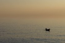 Fisherman on water at sunset, Camogli, Liguria, Italy — Stock Photo