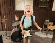 Children playing guitar and drums in band — Stock Photo