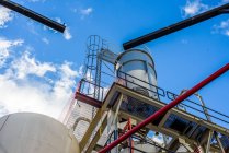 Low angle view of storage tanks and pipes at biofuel industrial plant — Stock Photo