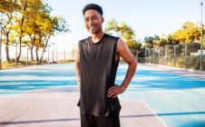 Портрет усміхненого юнака на баскетбольному майданчику — стокове фото