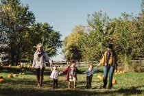 Women and children holding hands in field of pumpkins, Oshawa, Canada, North America — Stock Photo