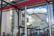 Storage tanks and industrial piping at biofuel plant — Stock Photo