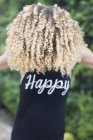 Woman in top with word Happy — Stock Photo