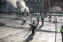 Construction workers laying foundation of building — Stock Photo