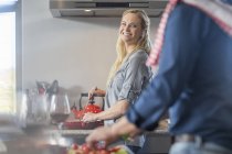 Man and woman in kitchen preparing food — Stock Photo