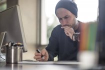 Young male designer working at home desk — Stock Photo