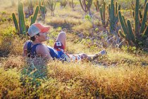 Людина відпочити в траві, оточений кактусів, Жерікоакоара Національний парк, Сеара, Бразилія — стокове фото