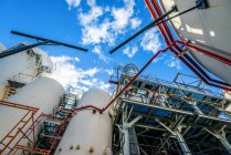Low angle view of storage tanks and industrial piping at biofuel plant — Stock Photo