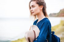 Woman standing near coastline and looking at view — Stock Photo
