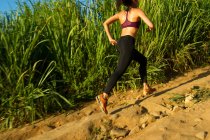 Female runner training on dirt track — Stock Photo