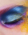 Close up of woman eye with colored powder eye shadow — Stock Photo
