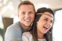 Young couple laughing at beach party — Stock Photo