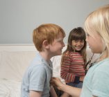 Drei Kinder spielen mit Stethoskop in Arzt — Stockfoto