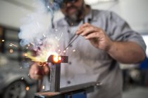 Man welding in bodywork repair shop — Stock Photo